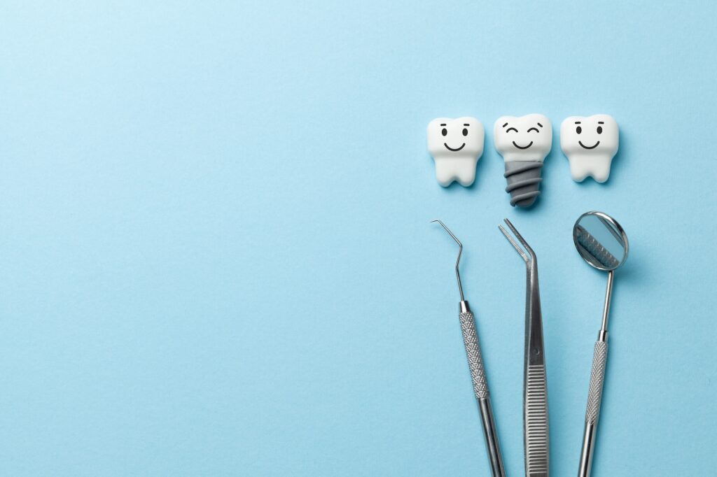 Dentist tools with Smiling teeth with metal implant